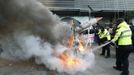 Policemen use fire extinguishers to put out flames after anti-North Korean protesters burned a mock North Korean missile, its flag and an effigy of the North's leader Kim Jong-Un during a protest blaming the North's rocket launch in central Seoul December 12, 2012. North Korea successfully launched a rocket on Wednesday, boosting the credentials of its new leader and stepping up the threat the isolated and impoverished state poses to its opponents. The rocket, which North Korea says put a weather satellite into orbit, has been labelled by the United States, South Korea and Japan as a test of technology that could one day deliver a nuclear warhead capable of hitting targets as far as the continental United States. REUTERS/Lee Jae-Won (SOUTH KOREA - Tags: MILITARY POLITICS SCIENCE TECHNOLOGY CIVIL UNREST)