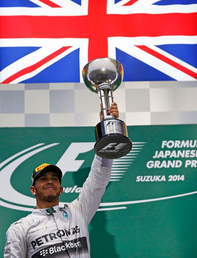 Mercedes Formula One driver Lewis Hamilton of Britain celebrates after winning the Japanese F1 Grand Prix at the Suzuka Circuit October 5, 2014. REUTERS/Toru Hanai (JAPAN