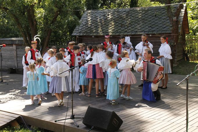 Učitel Vlastimil Ondra s harmonikou a s dětmi ze svého folklorního souboru Nivnička na folklorním festivalu ve Strážnici