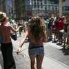 A woman take off her bra as she takes part in a topless march in New York