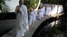 A Buddhist nun walks in line with novice Thai nuns at the Sathira Dammasathan Buddhist meditation centre in Bangkok