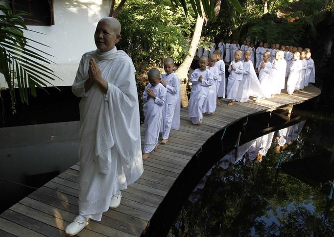 A Buddhist nun walks in line with novice Thai nuns at the Sathira Dammasathan Buddhist meditation centre in Bangkok