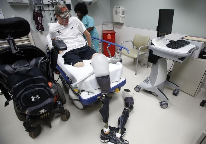 Sgt. Matt Krumwiede of the U.S. Army gets onto a gurney at Brooke Army Medical Center in San Antonio, Texas August 1, 2013. On June 12, 2012, Krumwiede was on patrol in Afghanistan when he stepped on an IED, which tore away both his legs, damaged his left arm, and ripped open his abdominal cavity. The 22-year-old has since undergone around 40 surgeries and is learning to walk with prosthetic legs. He is keen to re-join the infantry as soon as his injuries allow. U.S. troops have been in Afghanistan since 2001. Thousands of Afghan elders gathered in Kabul on November 21, 2013 at a Loya Jirga, or grand council, to debate a crucial security pact with the United States, a day after Kabul and Washington reached a draft agreement laying out the terms under which U.S. troops may stay beyond 2014. Picture taken August 1, 2013