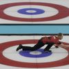 Canada's skip Jacobs delivers the stone during their men's curling round robin game against Switzerland at the 2014 Sochi Olympics in the Ice Cube Curling Center in Sochi