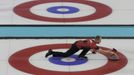 Canada's skip Brad Jacobs delivers the stone during their men's curling round robin game against Switzerland at the 2014 Sochi Olympics in the Ice Cube Curling Center in