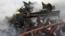 People help rescue workers lift a water hose to extinguish a fire after a plane crashed into a neighbourhood in Ishaga district, an outskirt of Nigeria's commercial capital Lagos June 3, 2012. There were no survivors among the 147 people on board a domestic passenger aircraft that crashed in the Nigerian city of Lagos on Sunday, an official of the National Emergency Management Agency (NEMA), told Reuters. REUTERS/Akintunde Akinleye (NIGERIA - Tags: DISASTER TRANSPORT) Published: Čer. 3, 2012, 9:47 odp.