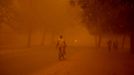 Niger. A sandstorm rolls in across Niamey, the capital of Niger, cutting out the sun and imersing the city in a strange red light. 4/6/12. Credit: The Times Online rights must be cleared by N.I.Syndication