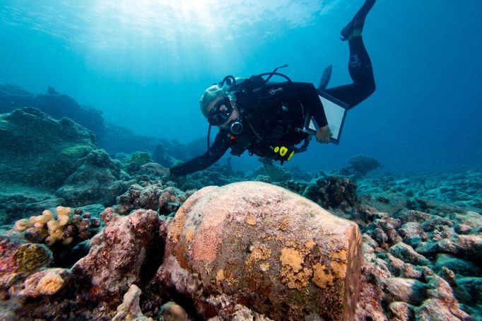 Maritime archaeologist Dr. Kelly Gleason with the Papahanaumokuakea Marine National Monument is shown with a ginger jar from the 19th-century.