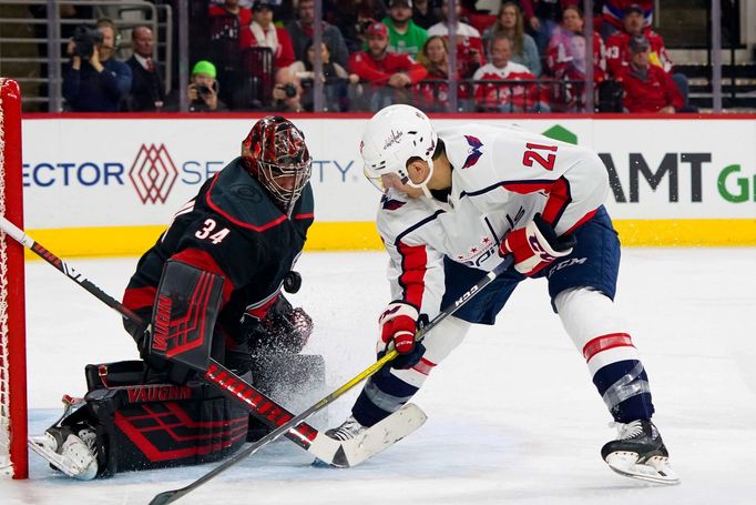 Jan 3, 2020; Raleigh, North Carolina, USA;  Carolina Hurricanes goaltender Petr Mrazek (34) stops a break away shot against Washington Capitals right wing Garnet Hathaway