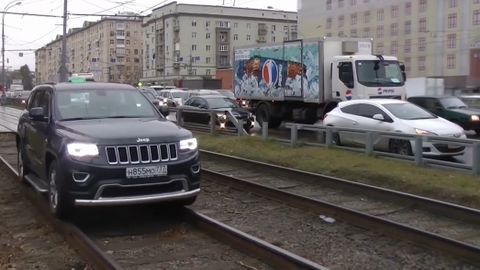 Nelítostné souboje v Moskvě. Řidiči jezdí po chodníku a kolejích, druzí jim v tom brání