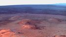 Opportunity's Eighth Anniversary View From 'Greeley Haven' (False Color) This mosaic of images taken in mid-January 2012 shows the windswept vista northward (left) to northeastward (right) from the location where NASA's Mars Exploration Rover Opportunity is spending its fifth Martian winter, an outcrop informally named "Greeley Haven." Opportunity's Panoramic Camera (Pancam) took the component images as part of full-circle view being assembled from Greeley Haven. The view includes sand ripples and other wind-sculpted features in the foreground and mid-field. The northern edge of the the "Cape York" segment of the rim of Endeavour Crater forms an arc across the upper half of the scene. Opportunity landed on Mars on Jan. 25, 2004, Universal Time and EST (Jan. 24, PST). It has driven 21.4 miles (34.4 kilometers) as of its eighth anniversary on the planet. In late 2011, the rover team drove Opportunity up onto Greeley Haven to take advantage of the outcrop's sun-facing slope to boost output from the rover's dusty solar panels during the Martian winter. Research activities while at Greeley Haven include a radio-science investigation of the interior of Mars, inspections of mineral compositions and textures on the outcrop, and monitoring of wind-caused changes on scales from dunes to individual soil particles. The image combines exposures taken through Pancam filters centered on wavelengths of 753 nanometers (near infrared), 535 nanometers (green) and 432 nanometers (violet). The view is presented in false color to make some differences between materials easier to see. Image credit: NASA/JPL-Caltech/Cornell/Arizona State Univ.