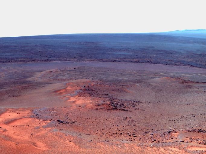 Opportunity's Eighth Anniversary View From 'Greeley Haven' (False Color) This mosaic of images taken in mid-January 2012 shows the windswept vista northward (left) to northeastward (right) from the location where NASA's Mars Exploration Rover Opportunity is spending its fifth Martian winter, an outcrop informally named "Greeley Haven." Opportunity's Panoramic Camera (Pancam) took the component images as part of full-circle view being assembled from Greeley Haven. The view includes sand ripples and other wind-sculpted features in the foreground and mid-field. The northern edge of the the "Cape York" segment of the rim of Endeavour Crater forms an arc across the upper half of the scene. Opportunity landed on Mars on Jan. 25, 2004, Universal Time and EST (Jan. 24, PST). It has driven 21.4 miles (34.4 kilometers) as of its eighth anniversary on the planet. In late 2011, the rover team drove Opportunity up onto Greeley Haven to take advantage of the outcrop's sun-facing slope to boost output from the rover's dusty solar panels during the Martian winter. Research activities while at Greeley Haven include a radio-science investigation of the interior of Mars, inspections of mineral compositions and textures on the outcrop, and monitoring of wind-caused changes on scales from dunes to individual soil particles. The image combines exposures taken through Pancam filters centered on wavelengths of 753 nanometers (near infrared), 535 nanometers (green) and 432 nanometers (violet). The view is presented in false color to make some differences between materials easier to see. Image credit: NASA/JPL-Caltech/Cornell/Arizona State Univ.