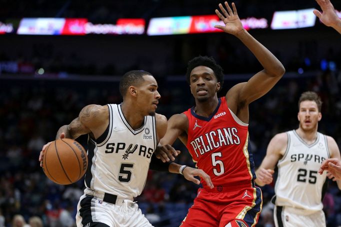 Feb 12, 2022; New Orleans, Louisiana, USA; San Antonio Spurs guard Dejounte Murray (5) is defended by New Orleans Pelicans forward Herbert Jones (5) in the first quarter