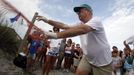 South Carolina United Turtle Enthusiasts (SCUTE), head coordinator Phil Schneider removes a protective fencing before a nest inventory on Pawleys Island, South Carolina August 10, 2012. According to SCUTE, 70% of the eggs hatch and go out to sea where their organization and their volunteers work. The number one predator to the eggs are ghost crabs. Turtle volunteers walk the area's beaches along South Carolina's coast daily during the nesting season, looking for signs of turtle activity and keeping tabs on the progress of the endangered species of turtles that lay their eggs along the coast. Photo taken August 10, 2012. REUTERS/Randall Hill (UNITED STATES - Tags: ANIMALS ENVIRONMENT) Published: Srp. 21, 2012, 12:52 odp.