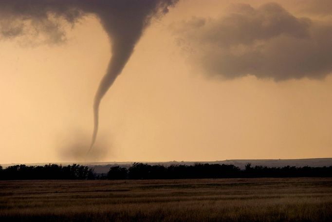 Tornado Moving Across Farmland in Oklahoma An F3 class tornado moves across farmland in Arnett, Oklahoma. Strong tornadoes like this one usually develop from a specific type of thunderstorm called supercells, which contain mesocyclones. Mesocyclones are a large area of rotating updraft in the atmosphere, between 1 and 6 miles across, that can cause tornadoes to form. | Location: Arnett, Oklahoma, USA.