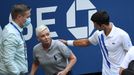 Sep 6, 2020; Flushing Meadows, New York, USA; Novak Djokovic of Serbia and a tournament official tend to a linesperson who was struck with a ball by Djokovic against Pabl