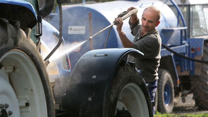 Zdeněk Zich umývá svůj traktor. V družstvu Agrospol to tak dělají po každém návratu z pole.