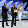 Director Nuri Bilge Ceylan, Palme d'Or award winner for his film &quot;Winter Sleep&quot;, poses on stage surrounded by director Quentin Tarantino and actress Uma Thurman during the closing ceremony o