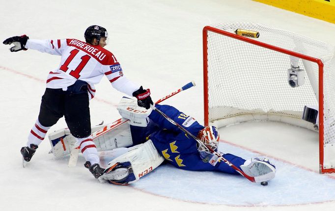 Sweden's goalie Anders Nilsson saves a penalty shot of Canada's Jonathan Huberdeau (L) during the first period of their men's ice hockey World Championship Group A game a