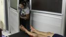 People peek into the emergency ward near the bloody legs of a woman who had been assaulted by her husband at a local hospital in San Pedro Sula March 20, 2013. San Pedro Sula, the country's second largest city after Tegucigalpa, has a homicide rate of 169 per 100,000 people and was named the world's most violent city for a second year in a row. Lax laws allow civilians to own up to five personal guns. Arms trafficking has flooded the country with nearly 70% illegal firearms. 83.4% of homicides are by firearms, compared to 60% in the United States. Picture taken March 20, 2013. REUTERS/Jorge Cabrera (HONDURAS - Tags: CRIME LAW CIVIL UNREST HEALTH) ATTENTION EDITORS: PICTURE 15 OF 39 FOR PACKAGE 'GUN CULTURE - HONDURAS' SEARCH 'HONDURAS GUN' FOR ALL IMAGES Published: Dub. 5, 2013, 11:14 dop.