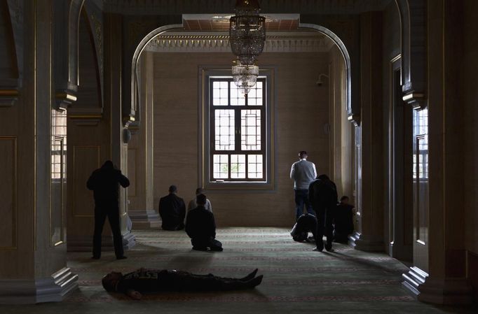 Muslim men wait for Friday prayers in the Heart of Chechnya Mosque in the Chechen capital Grozny April 26, 2013. The naming of two Chechens, Dzhokhar and Tamerlan Tsarnaev, as suspects in the Boston Marathon bombings has put Chechnya - the former site of a bloody separatist insurgency - back on the world's front pages. Chechnya appears almost miraculously reborn. The streets have been rebuilt. Walls riddled with bullet holes are long gone. New high rise buildings soar into the sky. Spotless playgrounds are packed with children. A giant marble mosque glimmers in the night. Yet, scratch the surface and the miracle is less impressive than it seems. Behind closed doors, people speak of a warped and oppressive place, run by a Kremlin-imposed leader through fear. Picture taken April 26, 2013. REUTERS/Maxim Shemetov (RUSSIA - Tags: SOCIETY POLITICS RELIGION) ATTENTION EDITORS: PICTURE 06 OF 40 FOR PACKAGE 'INSIDE MODERN CHECHNYA'. SEARCH 'REBUILDING CHECHNYA' FOR ALL IMAGES Published: Kvě. 1, 2013, 7:21 dop.