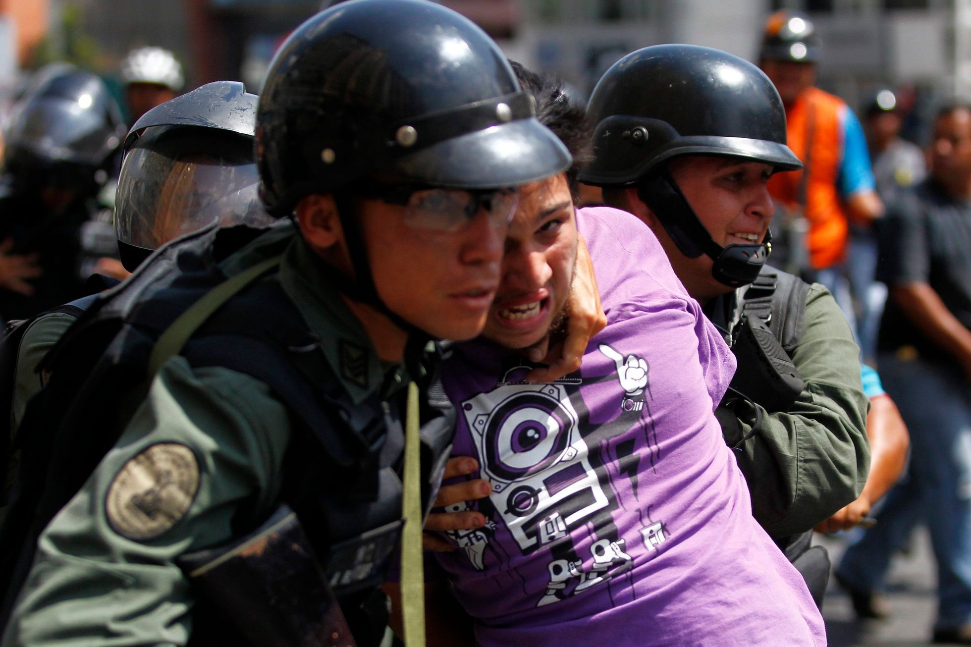 National guards detain a protester during riots in Caracas