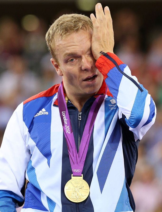 FILE PHOTO: Britain's gold medallist Chris Hoy cries on the podium during the victory ceremony for the track cycling men's keirin event at the Velodrome during the London