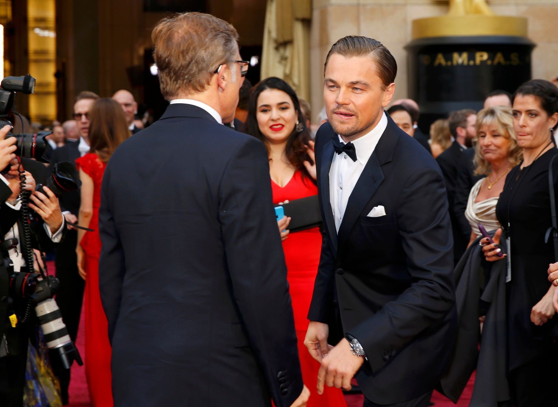 Leonardo DiCaprio greets actor Christoph Waltz on the red carpet at the 86th Academy Awards in Hollywood