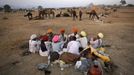 Camel herders sit in a group at Pushkar Fair in the desert Indian state of Rajasthan November 23, 2012. Many international and domestic tourists throng to Pushkar to witness one of the most colourful and popular fairs in India. Thousands of animals, mainly camels, are brought to the fair to be sold and traded. REUTERS/Danish Siddiqui (INDIA - Tags: SOCIETY ANIMALS) Published: Lis. 23, 2012, 5:37 odp.