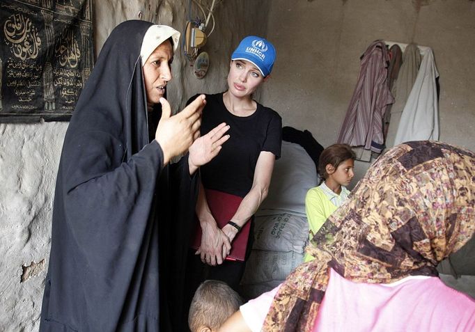 Picture released by the United Nations High Commissioner for Refugees (UNHCR) shows UNHCR goodwill ambassador, Angelina Jolie listening to a displaced Iraqi woman at a makeshift camp, at an undisclosed location northwest of Baghdad, on July 23, 2009. Jolie is on a one-day trip to Iraq to see first-hand the plight of hundreds of thousands of families uprooted by the ongoing conflict. The UNHCR refused to name the camp for security reasons.