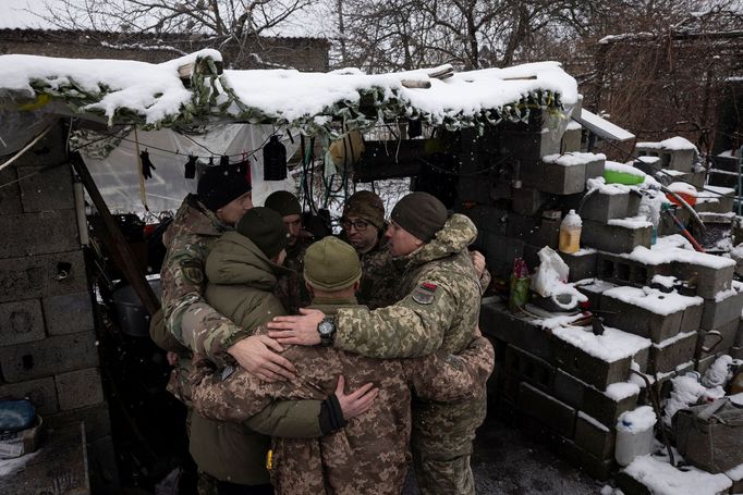 Military Chaplains Yevhen and Oleksandr pray with soldiers of the 93rd separate mechanized brigade during a Christmas Day service near the front line in the Donetsk regio