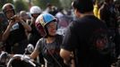 A woman rides a Harley Davidson motorcycle as she attends the annual Harley Davidson National Rally in Qian Dao Lake, in Zhejiang Province May 11, 2013. Around 1,000 Harley Davidson enthusiasts from all over China met to celebrate the 5th Harley Davidson National Rally in China, as part of the company's 110-year anniversary. Major Chinese cities ban motorcycles from circulating on highways and major avenues. Meanwhile, Harley Davidson motorbikes are considered by Chinese tax authorities to be luxury items, so they are taxed at extremely high rates-- sometimes the taxes alone is equivalent to the bike's U.S. price tag. Traffic and transportation authorities have also weighed in, putting Harleys in the same category as electric bikes, horses and bicycles, meaning that they cannot be on highways and major avenues. Picture taken May 11, 2013. REUTERS/Carlos Barria (CHINA - Tags: TRANSPORT SOCIETY) Published: Kvě. 13, 2013, 11:05 odp.