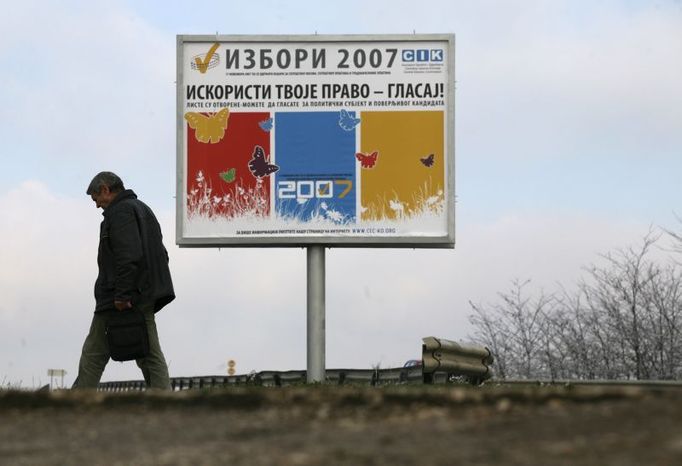 A man in the central Kosovo town of Lipljan walks past a billboard encouraging Serbs to vote in Saturday's parliamentary election in the breakaway Serbian province, November 13, 2007. Serb leaders in Belgrade and the influential Orthodox Church have told Kosovo's Serb minority to boycott the November 17 vote, to avoid giving legitimacy to an Albanian-dominated parliament threatening to declare independence. REUTERS/Hazir Reka (SERBIA)