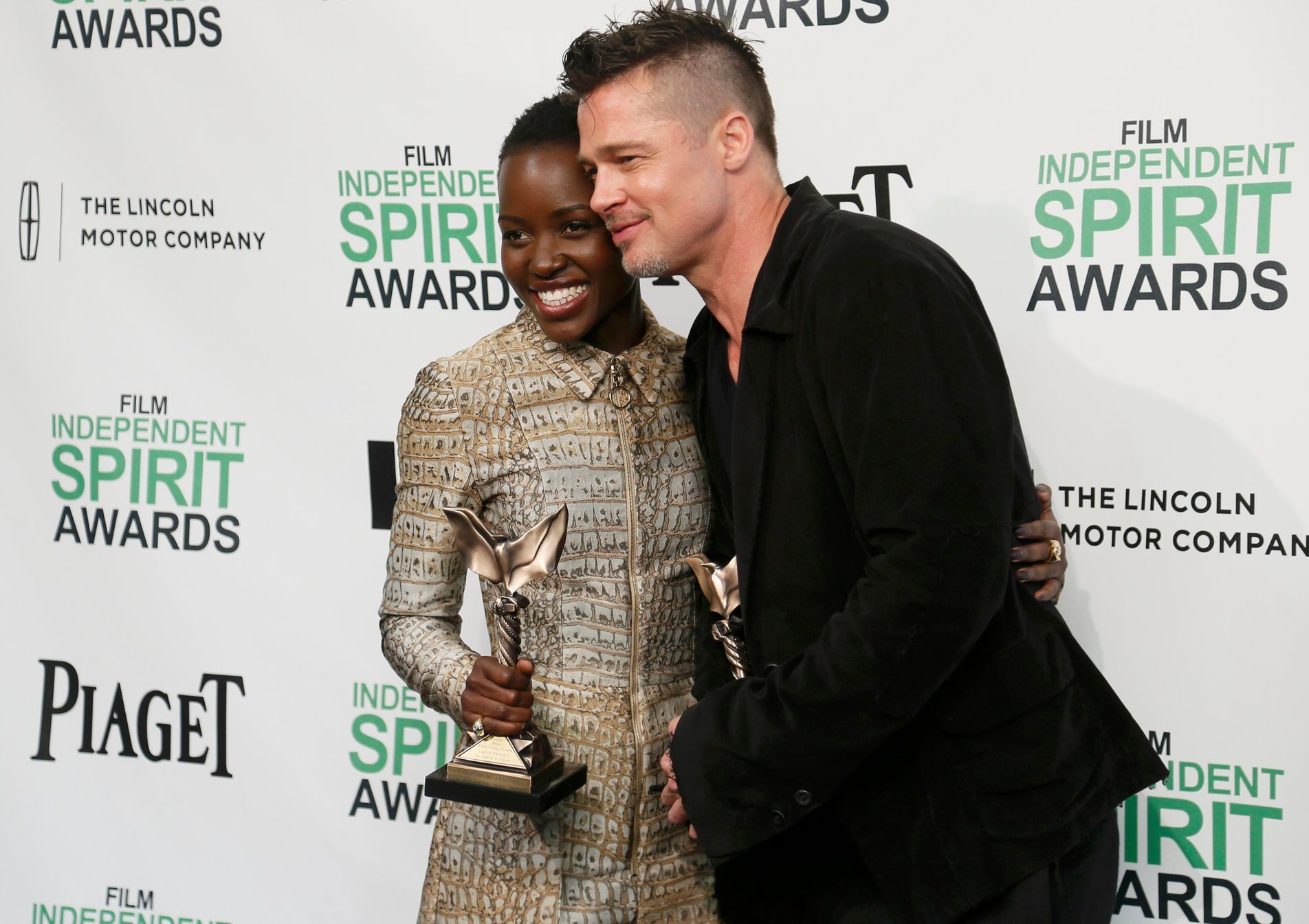 Producer Brad Pitt and actress Lupita Nyong'o pose with their awards for &quot;12 Years a Slave&quot; backstage at the 2014 Film Independent Spirit Awards in Santa Monica