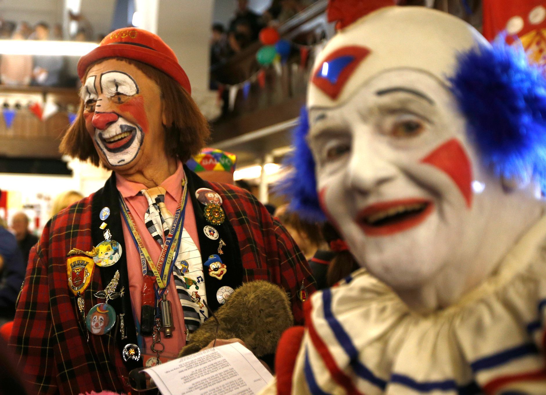 Clowns stand at the pews of the All Saints Church during the Grimaldi clown service in Dalston, north London