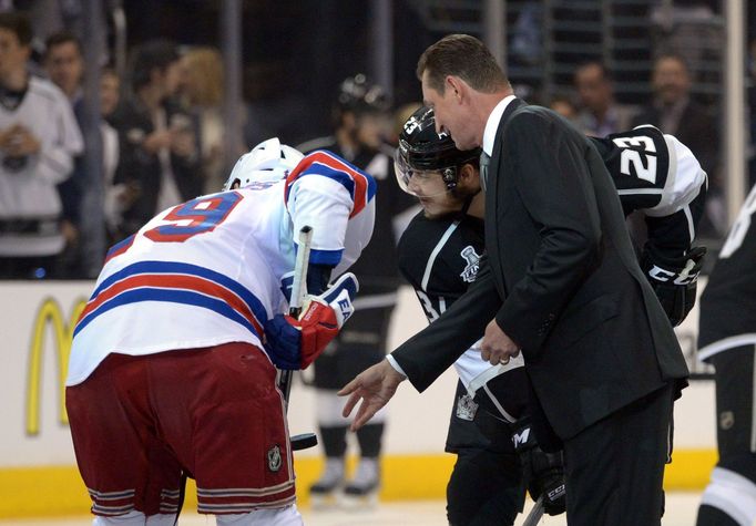 Jun 4, 2014; Los Angeles, CA, USA; Los Angeles Kings former player Wayne Gretzky drops the ceremonial puck with right wing Dustin Brown (23) and New York Rangers center B