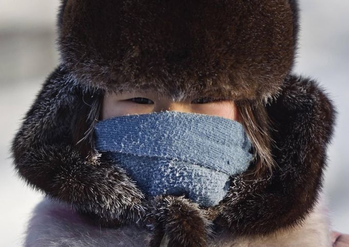 A girl poses for a picture in the village of Oymyakon, in the Republic of Sakha, northeast Russia, January 26, 2013. The coldest temperatures in the northern hemisphere have been recorded in Oymyakon valley, where according to the United Kingdom Met Office a temperature of -67.8 degrees Celsius (-90 degrees Fahrenheit) was registered in 1933 - the coldest on record in the northern hemisphere since the beginning of the 20th century. Yet despite the harsh climate, people live in the valley, and the area is equipped with schools, a post office, a bank, and even an airport runway (albeit open only in the summer). Picture taken January 26, 2013. REUTERS/Maxim Shemetov (RUSSIA - Tags: SOCIETY ENVIRONMENT) ATTENTION EDITORS: PICTURE 16 OF 27 FOR PACKAGE 'THE POLE OF COLD' SEARCH 'MAXIM COLD' FOR ALL IMAGES Published: Úno. 18, 2013, 11:26 dop.