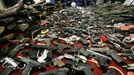 Guns cover tables in front of New Jersey Attorney General Jeffrey Chiesa, center at podium, in Camden, N.J., Tuesday, Dec. 18, 2012, as he announces last weekend's gun buyback event brought in more than 1,100 guns. He says it appears that the mass killing at a school in Newtown, Conn., may have motivated some to turn in their weapons for up to $250 each.(AP Photo/Mel Evans)