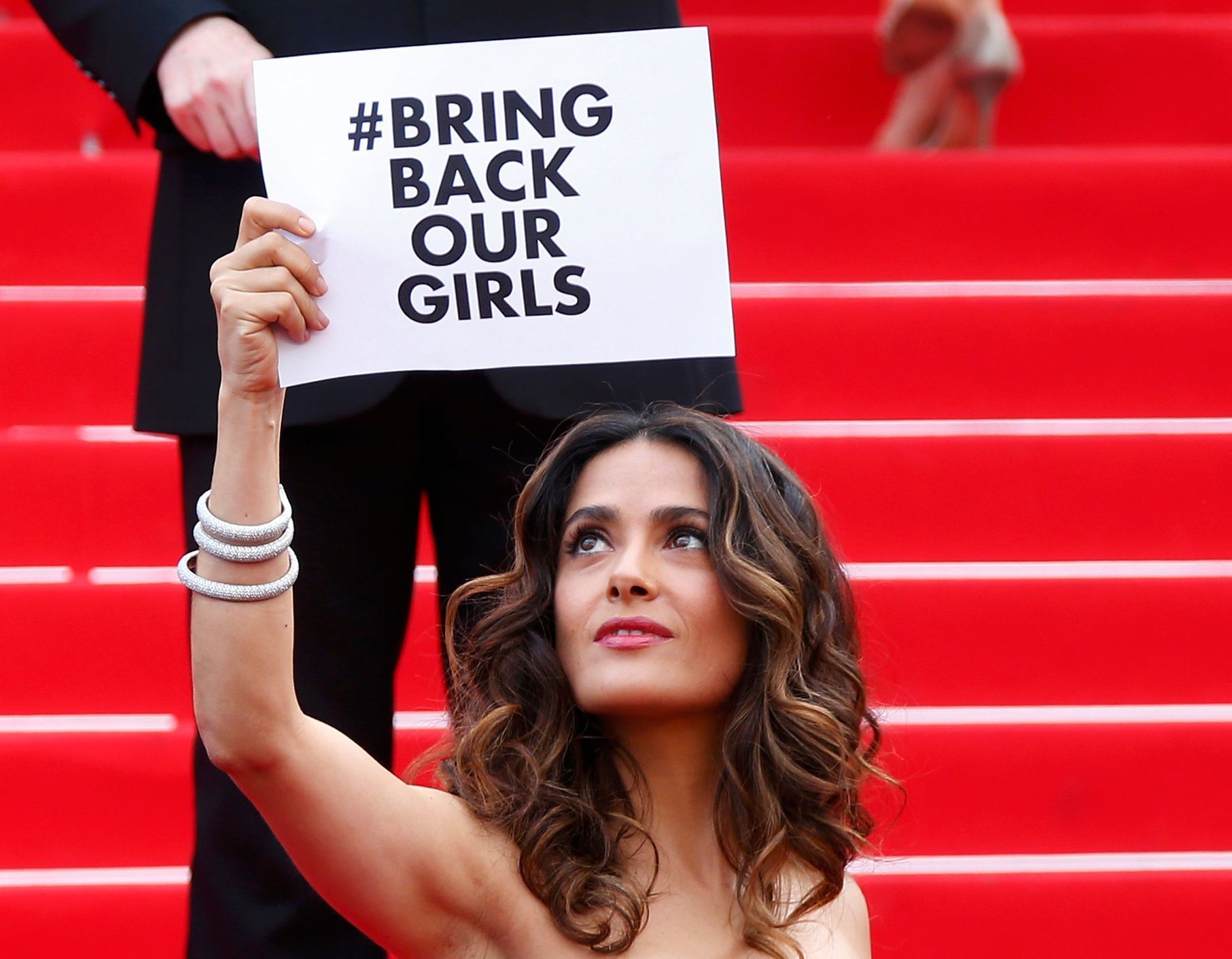 Actress and producer Salma Hayek holds a placard which reads &quot;Bring back our girls&quot; as she poses on the red carpet at the 67th Cannes Film Festival in Cannes