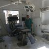 A medic inspects the damage inside a field hospital after airstrikes in a rebel held area of Aleppo