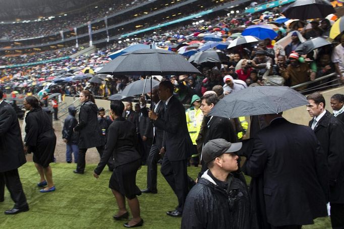 U.S. President Barack Obama enters the First National Bank Stadium during the mass memorial service for late South African President Nelson Mandela in Johannesburg December 10, 2013.