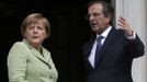 Greece's Prime Minister Antonis Samaras (R) and Germany's Chancellor Angela Merkel speak before their meeting at the Maximos mansion in Athens, October 9, 2012. Merkel makes her first visit to Greece since the eurozone crisis began here three years ago. Her five-hour stop is seen by the government as a historic boost for the country's future in Europe's shared currency, but by protesters as a harbinger of more austerity and hardship. REUTERS/Thanassis Stavrakis - POOL (GREECE - Tags: POLITICS BUSINESS) Published: Říj. 9, 2012, 12:21 odp.