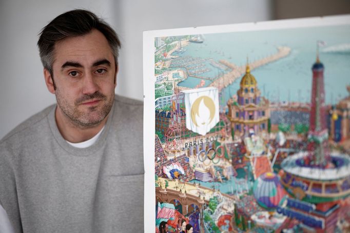 French artist Ugo Gattoni poses next to the official posters for the Paris 2024 Olympic and Paralympic Games during a presentation in Ivry-sur-Seine, near Paris, France,