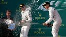 Race winner Mercedes Formula One driver Lewis Hamilton of Britain (R) sprays champagne next to team mate second placed Nico Rosberg of Germany (C) during the podium cerem