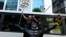 An anti-government demonstrator dressed as Batman yells slogans accompanied by passengers on a bus, during a protest against the 2014 World Cup in Rio de Janeiro June 12,