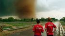 Storm Chasers Watch a Large Tornado Original caption:Storm chasers keep a close eye on a large tornado near Attica, Kansas on May 12, 2004.