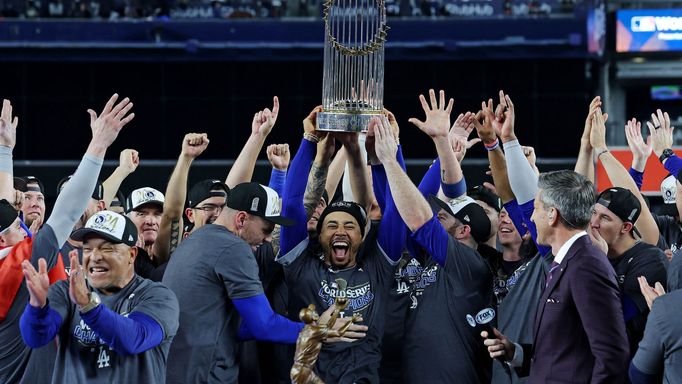 Oct 31, 2024; New York, New York, USA; Los Angeles Dodgers shortstop Mookie Betts (50) celebrates with the Commissioner’s Trophy after the Los Angeles Dodgers beat the Ne