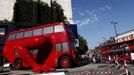 A London bus that has been transformed into a robotic sculpture by Czech artist David Cerny is assembled in front of the Czech Olympic headquarters in London July 22, 2012. The bus, which Cerny hopes could become an unofficial mascot of the London 2012 Olympic Games, does push-ups with the help of an engine powering a pair of robotic arms and the motion is accompanied by a recording of sounds evoking tough physical effort. It will be parked outside the Czech Olympic headquarters in London for the duration of the Games. REUTERS/Marika Kochiashvili (UNITED KINGDOM - Tags: SOCIETY SPORT OLYMPICS TRANSPORT) Published: Čec. 22, 2012, 6:02 odp.