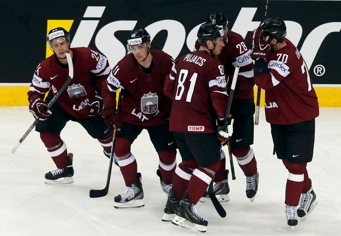 Latvia's Kristaps Sotnieks (2nd L) celebrates his foal against Finland with team mates during the third period of their men's ice hockey World Championship group B game a