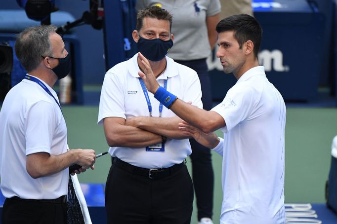 Sep 6, 2020; Flushing Meadows, New York, USA; Novak Djokovic of Serbia discusses with a tournament official after being defaulted for striking a lines person with a ball